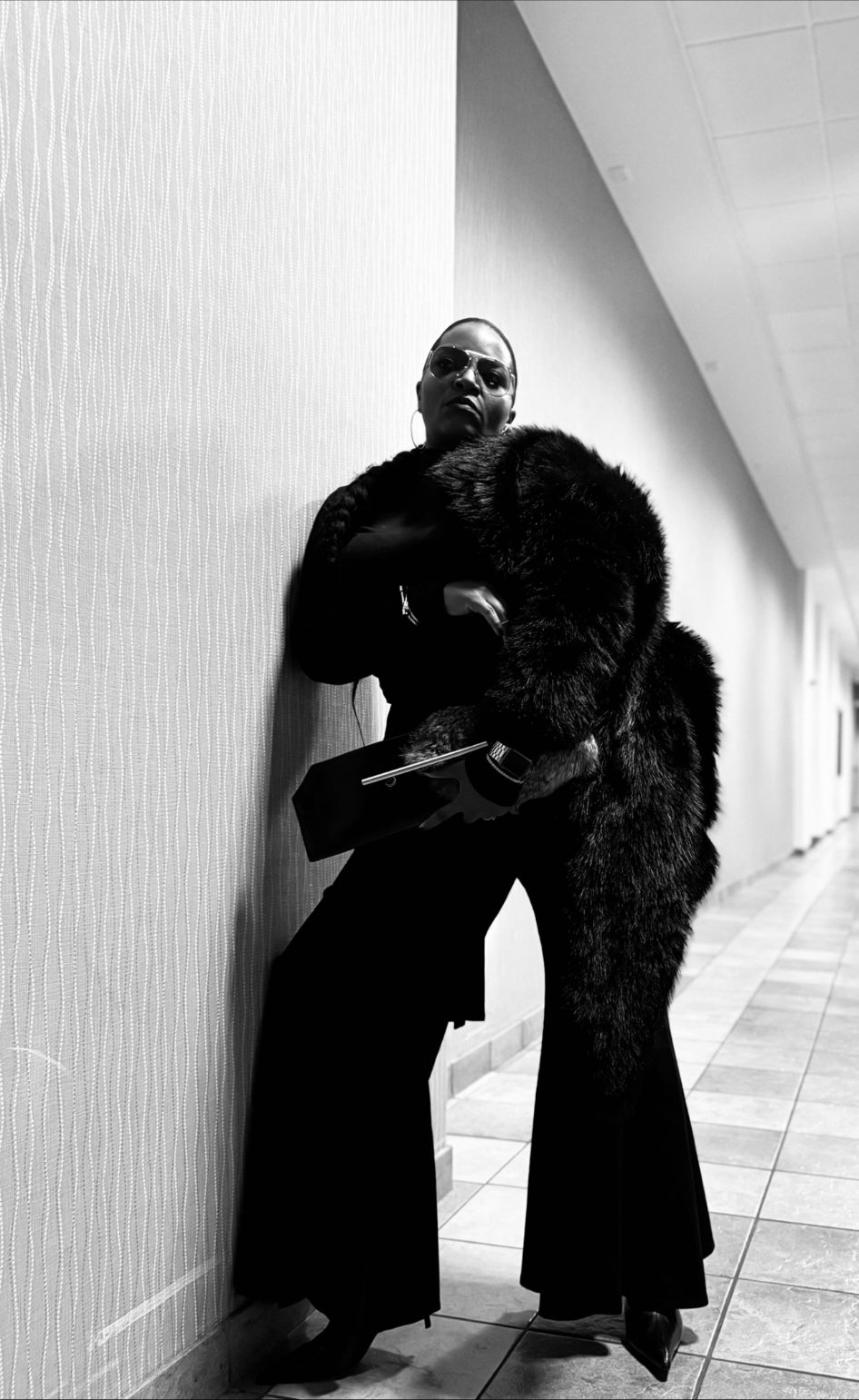 B&W editorial — fur coat leaning