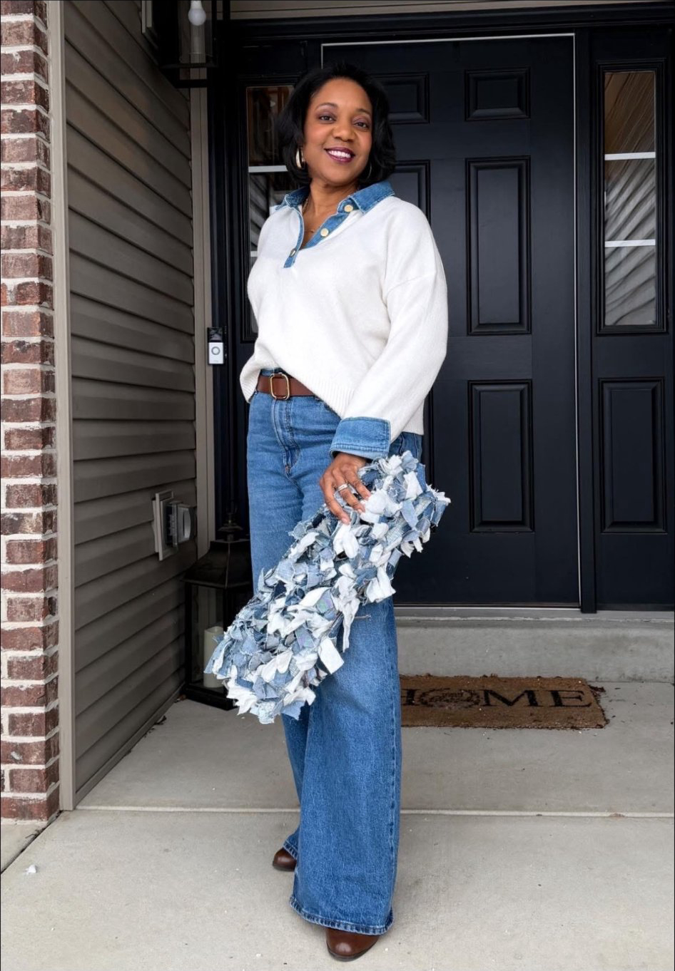 Denim fringe clutch — wide-leg jeans