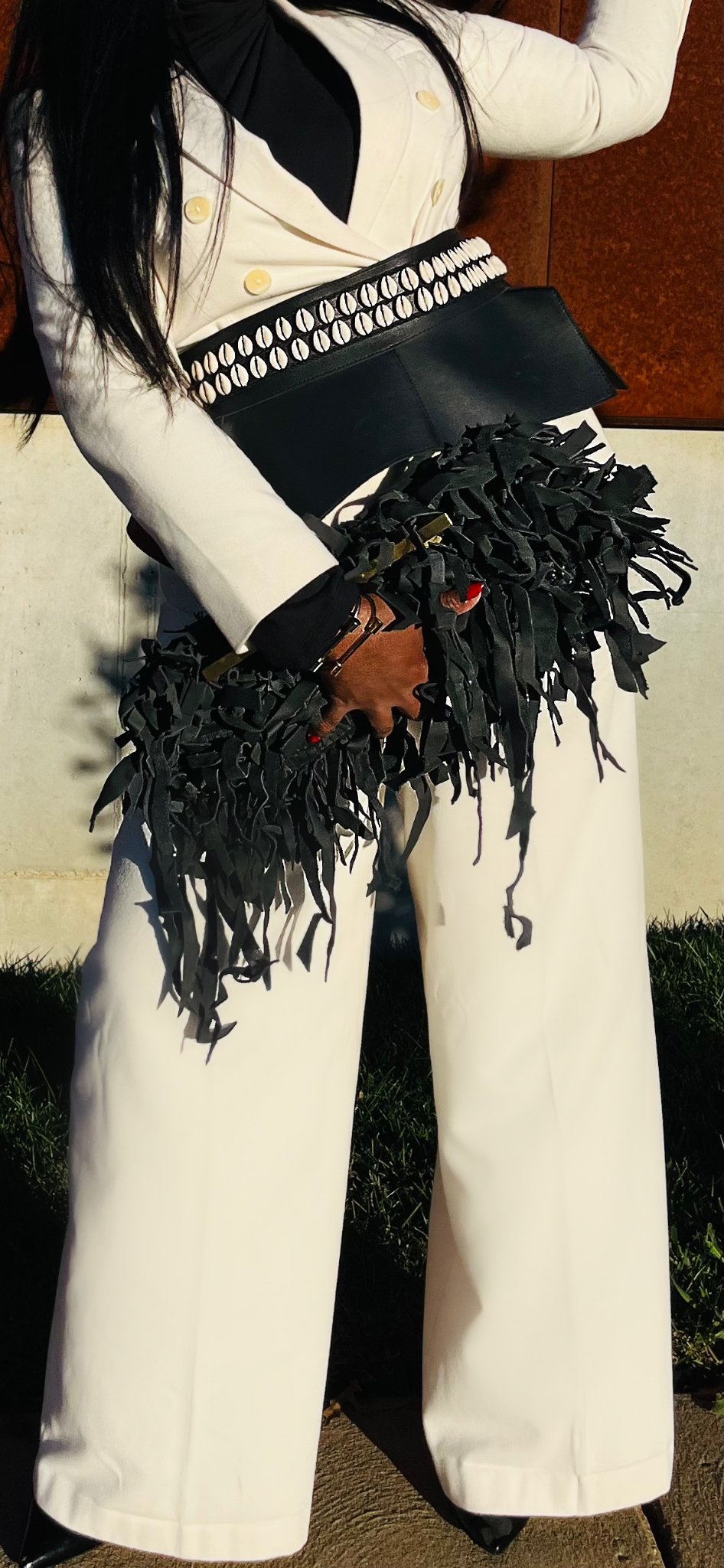 White suit fringe clutch close-up